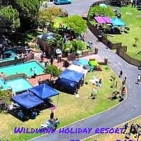 Aerial view of WildWind resort grounds with pool, lawns and Hottentots Holland mountains