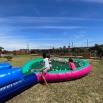 Children playing in a giant inflatable ball pool at WildWind resort