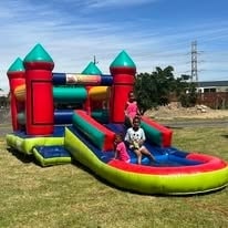 Colourful bouncy castle with slide at WildWind resort on a sunny day