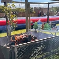 Braai spread with meat on the grill at a WildWind resort event