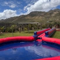 Giant inflatable slide with mountain backdrop at WildWind resort