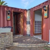WildWind resort ablution block with terracotta walls and wooden doors