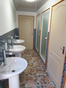 WildWind resort ablution facilities with clean sinks, showers and tiled floors