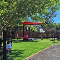 WildWind resort play area with equipment and open lawn for children