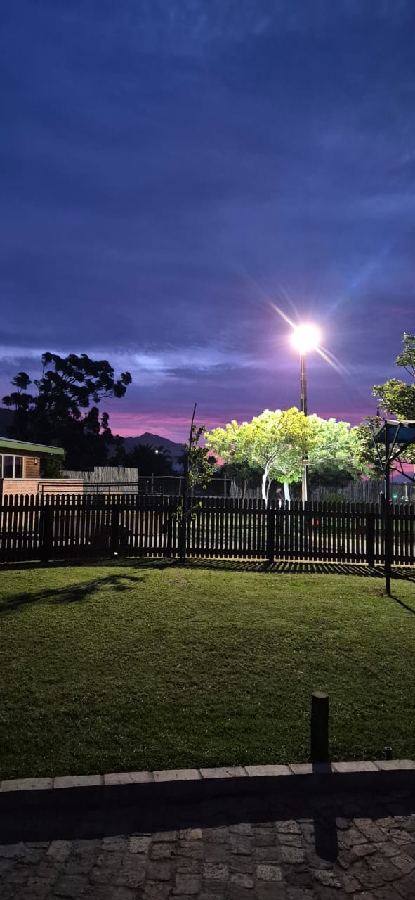 WildWind resort lawn at twilight with dramatic purple and pink sky