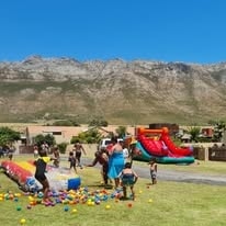Children enjoying inflatables at WildWind Family Resort with mountain backdrop