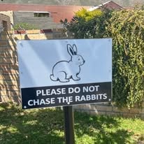 Charming hand-painted rabbit sign at WildWind resort entrance
